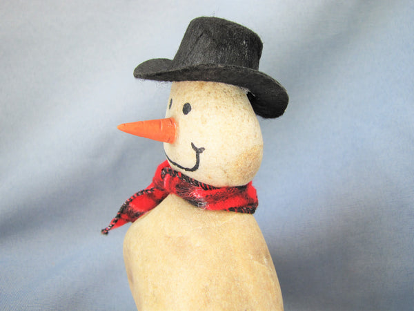 Snowman made of Stacked Stone - With Black Hat and Plaid Scarf