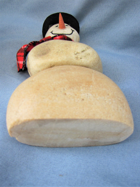 Snowman made of Stacked Stone - With Black Hat and Plaid Scarf