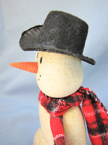 Snowman made of Stacked Stone - With Black Hat and Plaid Scarf